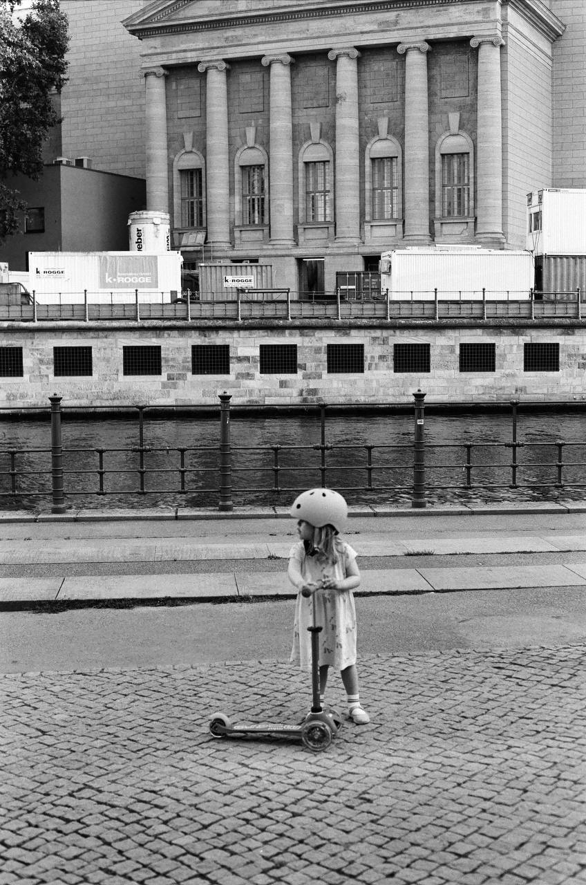 little girl with scooter captured on black and white film