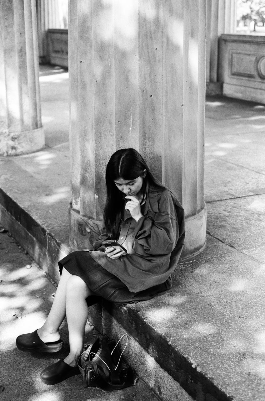sitting girl in sunlights captured on black and white film