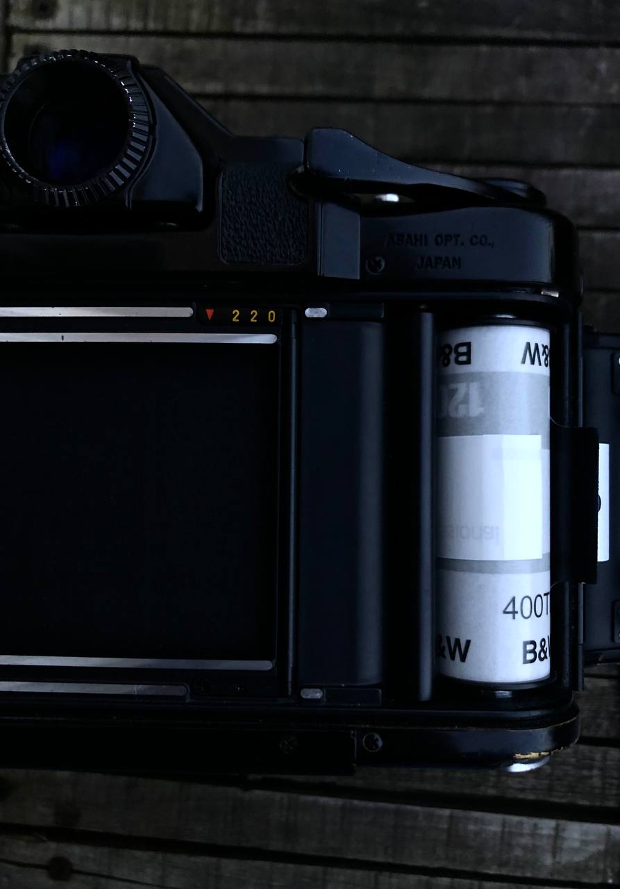 opened photo camera with black & white film
