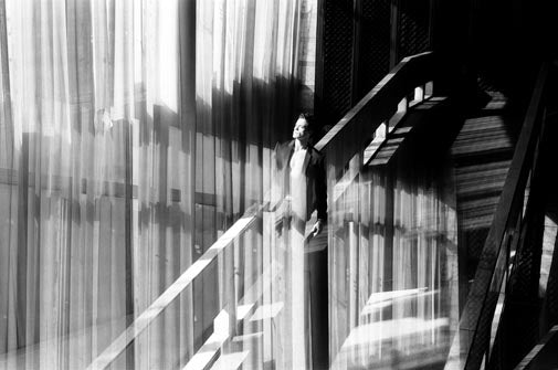 man on elevator captured on Ilford FP4 Plus black & white film